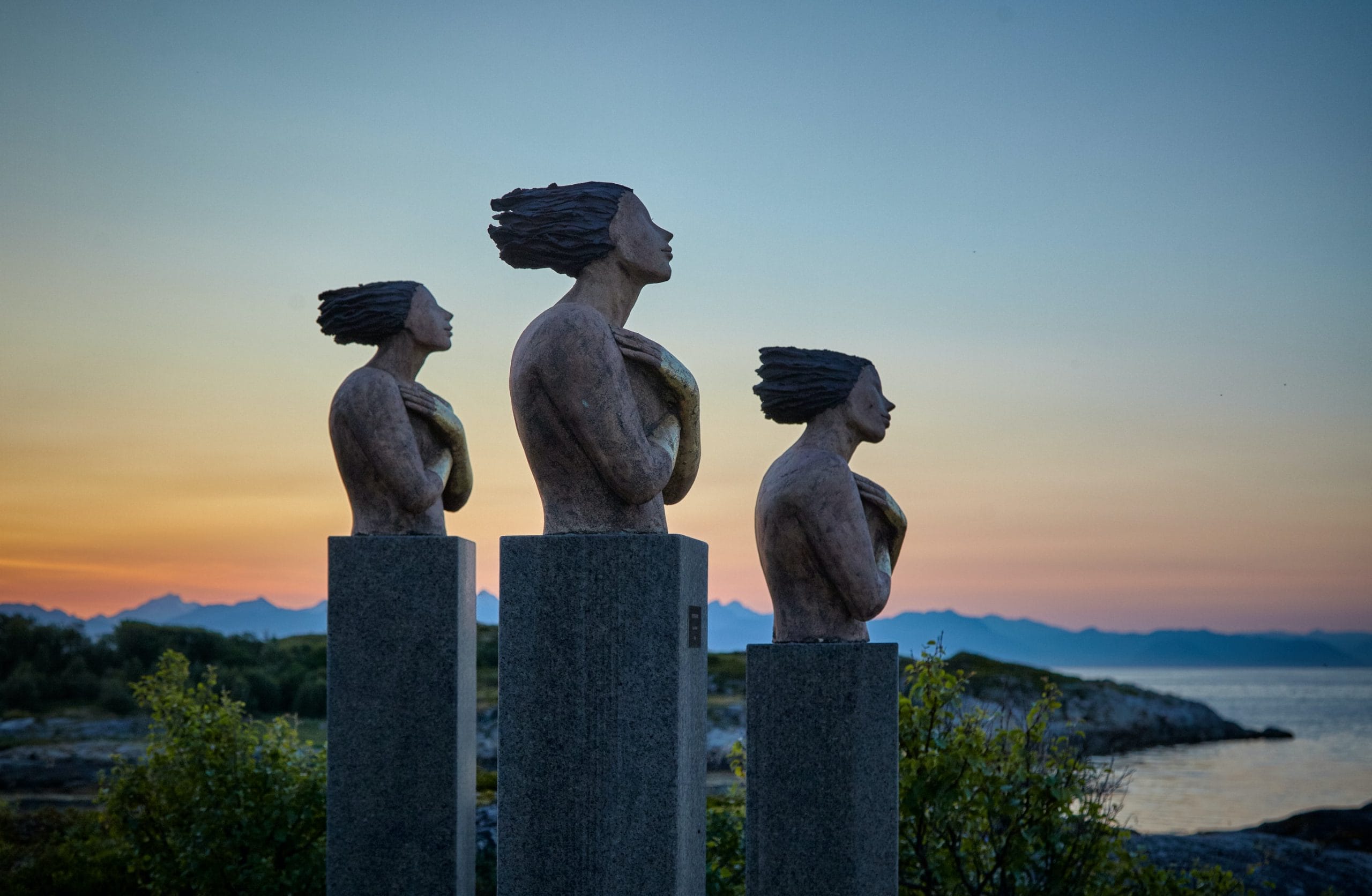 Image: Three outdoor scuptures of human busts at dusk, image by Vidar Nordli Mathisen